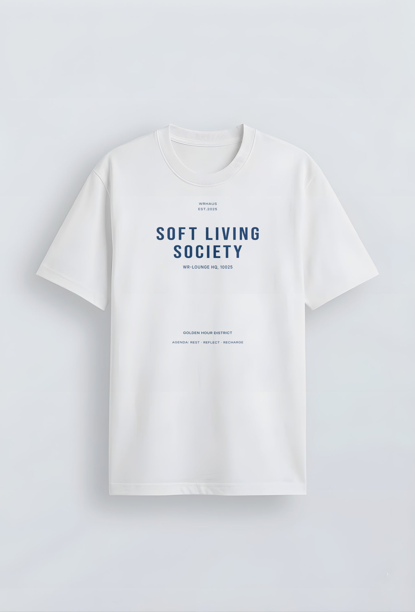 A premium white short-sleeved t-shirt with a structured relaxed fit. The center chest features bold, minimalist typographic designs that reads "SOFT LIVING SOCIETY" with smaller archival-style details below it.
