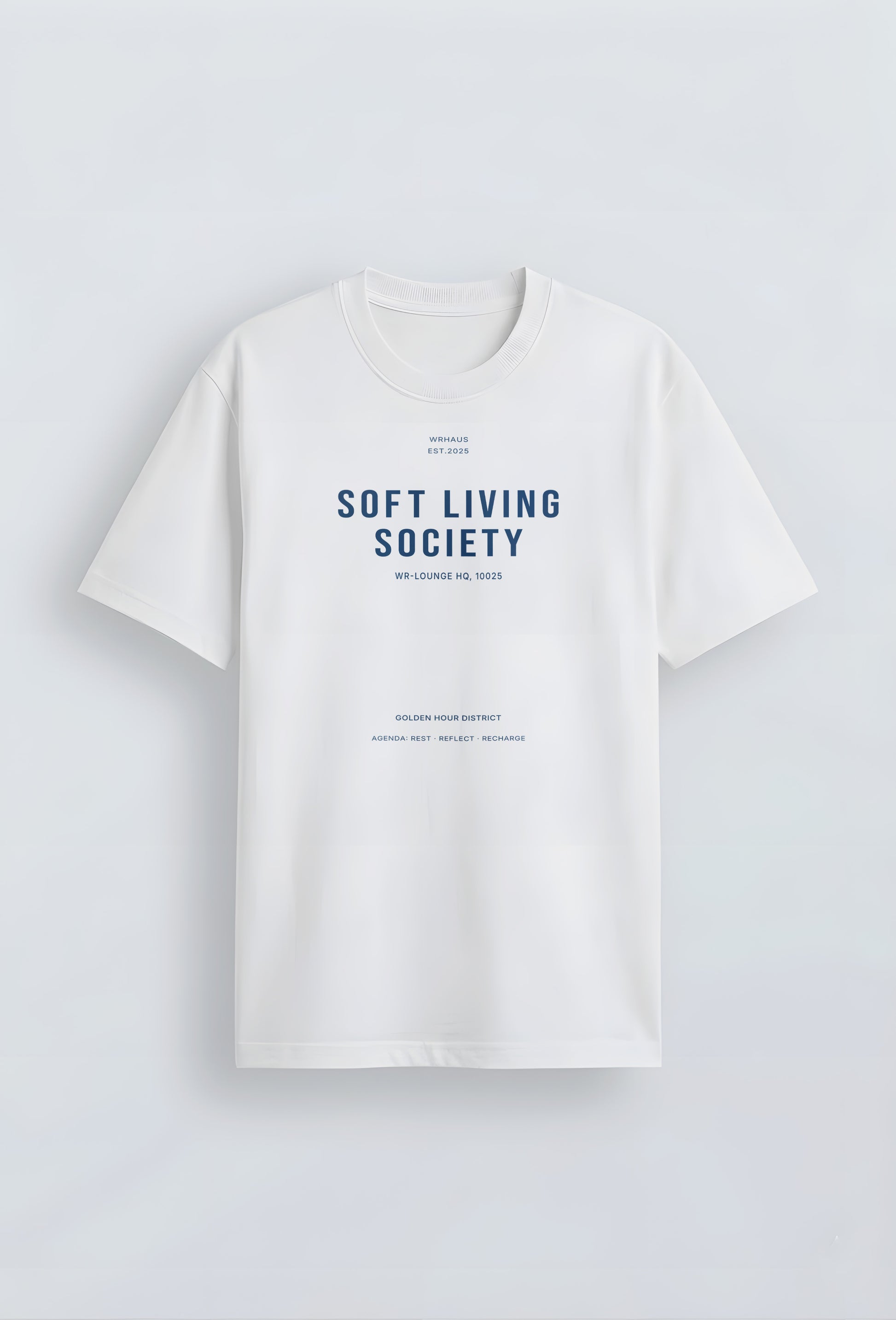 A premium white short-sleeved t-shirt with a structured relaxed fit. The center chest features bold, minimalist typographic designs that reads "SOFT LIVING SOCIETY" with smaller archival-style details below it.