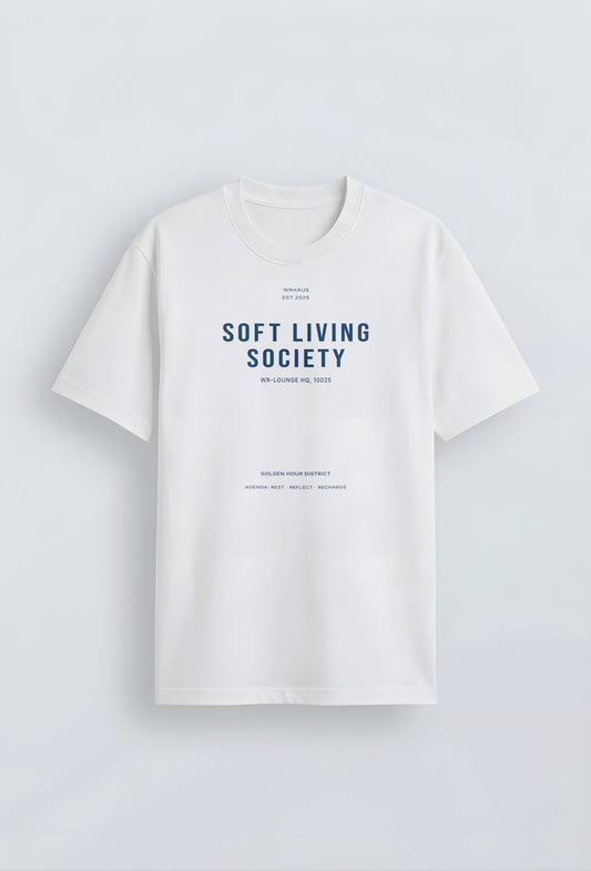 A premium white short-sleeved t-shirt with a structured relaxed fit. The center chest features bold, minimalist typographic designs that reads "SOFT LIVING SOCIETY" with smaller archival-style details below it.